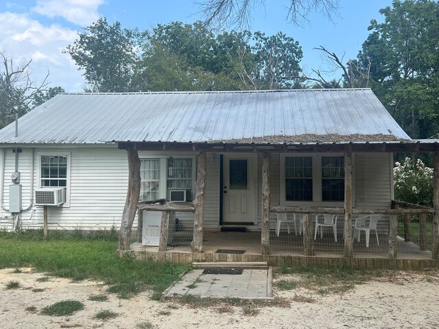 view of front of home featuring cooling unit and a porch