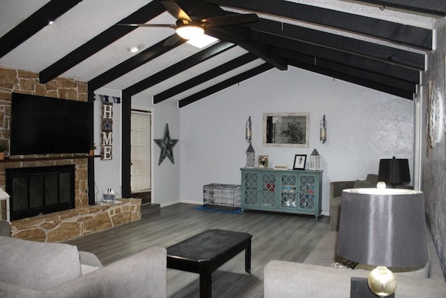 living room with a fireplace, ceiling fan, hardwood / wood-style floors, and lofted ceiling with beams