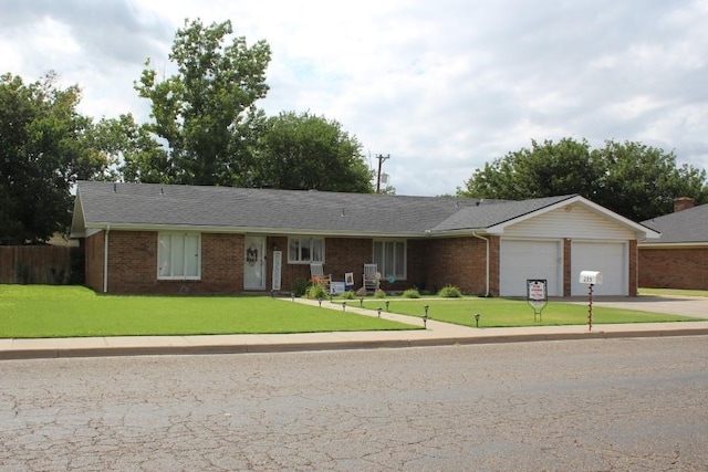 ranch-style home with a garage and a front yard