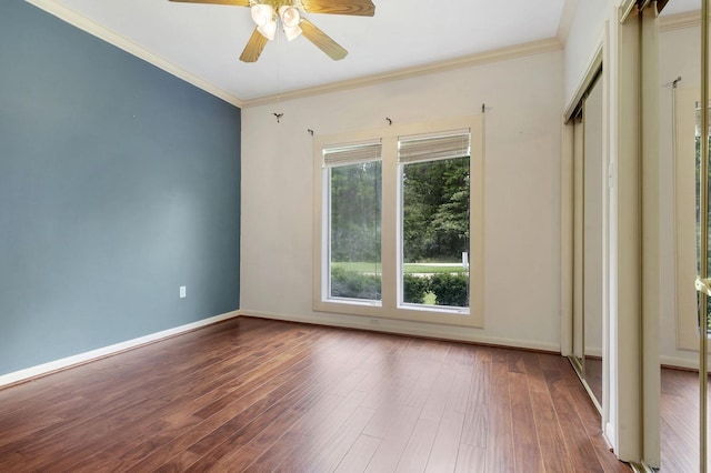 unfurnished room featuring ceiling fan, hardwood / wood-style floors, and ornamental molding