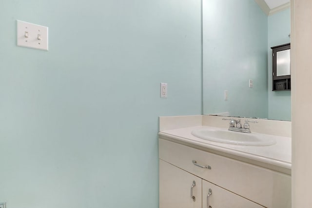 bathroom featuring crown molding and vanity