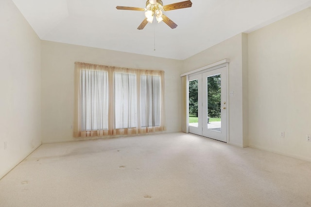 carpeted empty room featuring ceiling fan and french doors