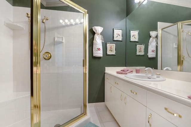 bathroom with tile patterned flooring, vanity, a shower with shower door, and crown molding