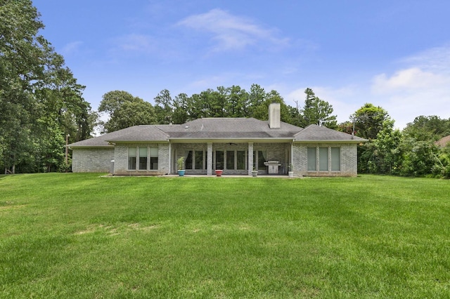 rear view of house with a yard