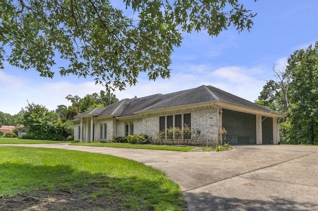 ranch-style home featuring a front yard and a garage