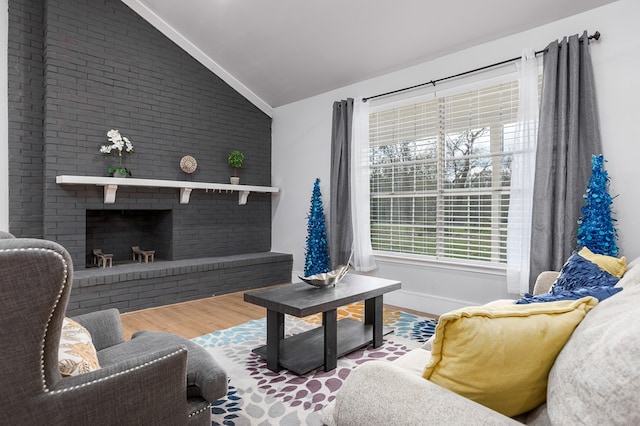 living room with wood-type flooring, lofted ceiling, and a fireplace