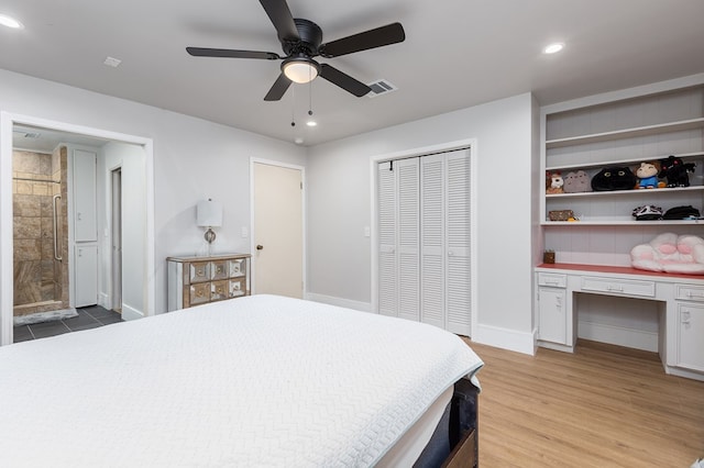 bedroom with ceiling fan, a closet, built in desk, and light wood-type flooring