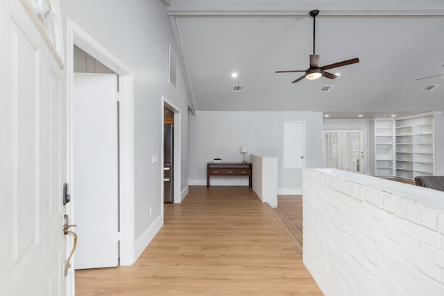 hall featuring light hardwood / wood-style flooring and built in features