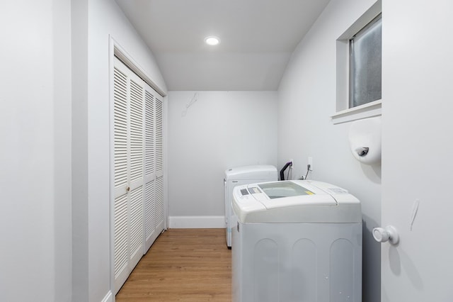 laundry room featuring washer and dryer and light wood-type flooring