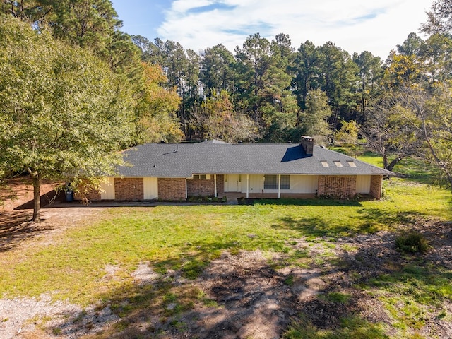 ranch-style home featuring a front yard