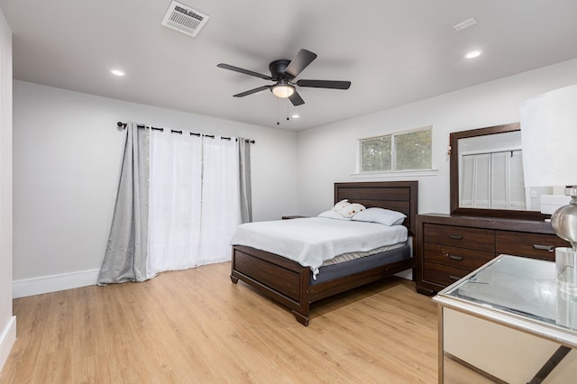 bedroom with ceiling fan and light hardwood / wood-style flooring