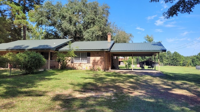 rear view of house with a yard and a carport