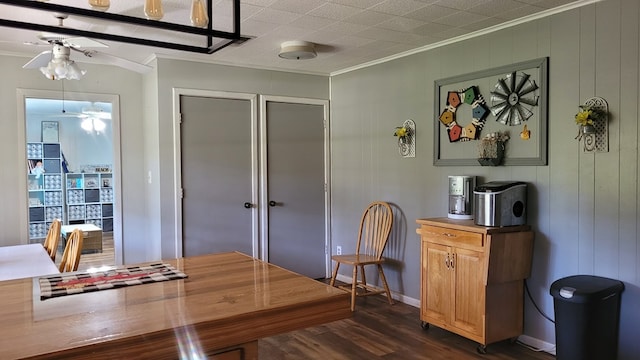 dining space featuring dark hardwood / wood-style flooring, ceiling fan, and ornamental molding