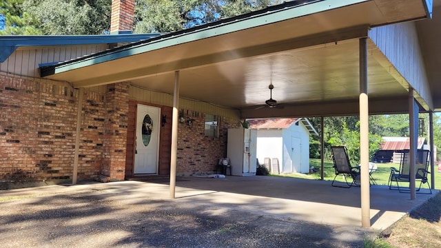 exterior space featuring ceiling fan and a shed