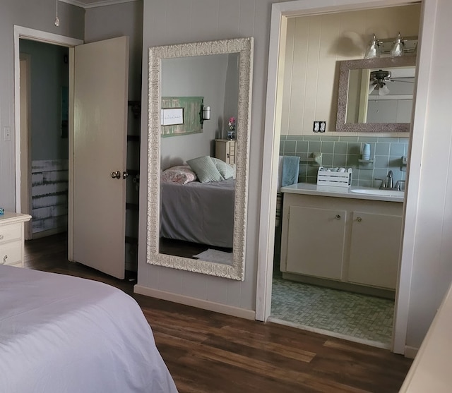 bedroom with dark hardwood / wood-style floors and sink