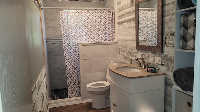 bathroom featuring hardwood / wood-style floors, vanity, toilet, and tile walls