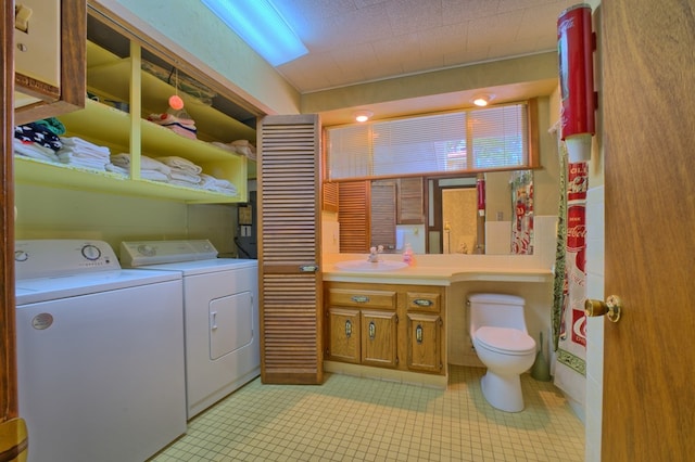 interior space featuring vanity, washing machine and dryer, toilet, tile patterned flooring, and a shower with shower curtain