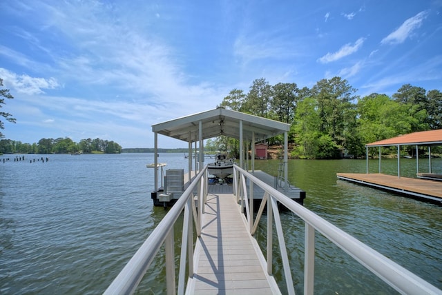view of dock with boat lift and a water view