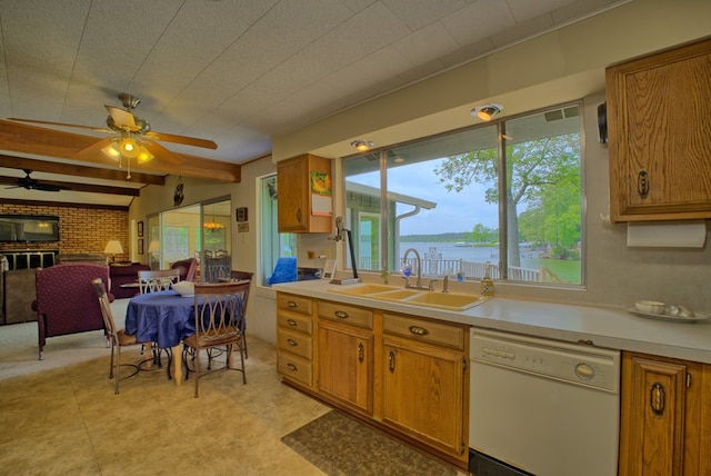 kitchen featuring light countertops, beam ceiling, a sink, brown cabinets, and dishwasher