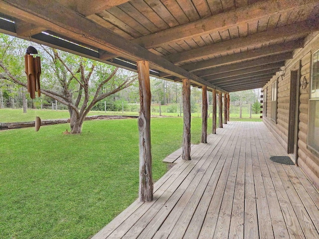 wooden terrace featuring a lawn