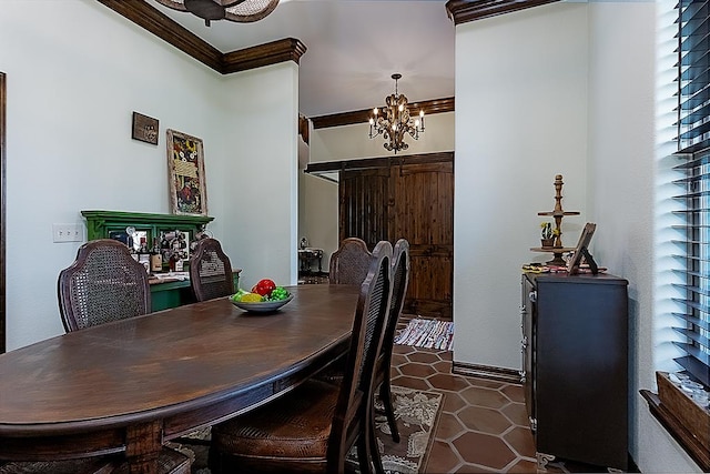 dining room featuring dark tile patterned flooring, crown molding, and a notable chandelier