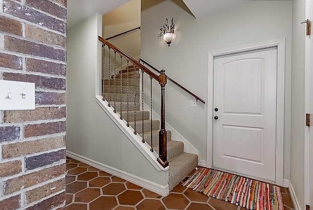 staircase featuring tile patterned flooring