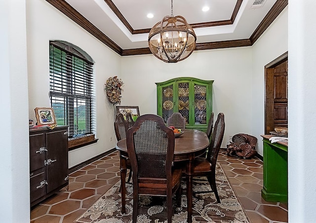 tiled dining space featuring ornamental molding, a tray ceiling, and a chandelier