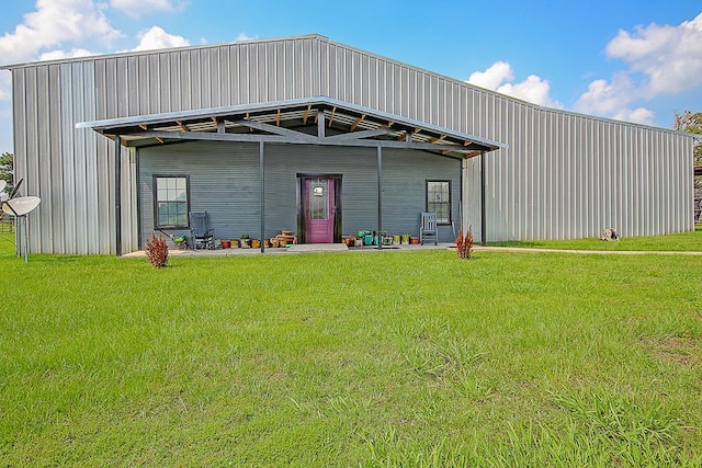 view of front facade with an outbuilding and a front yard