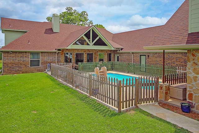 view of pool featuring a lawn and a patio