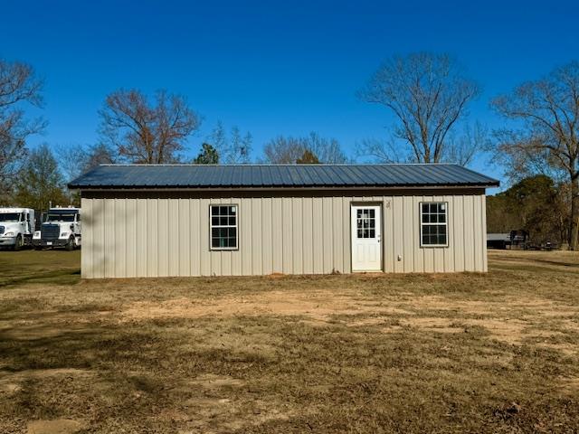 view of outbuilding with a yard