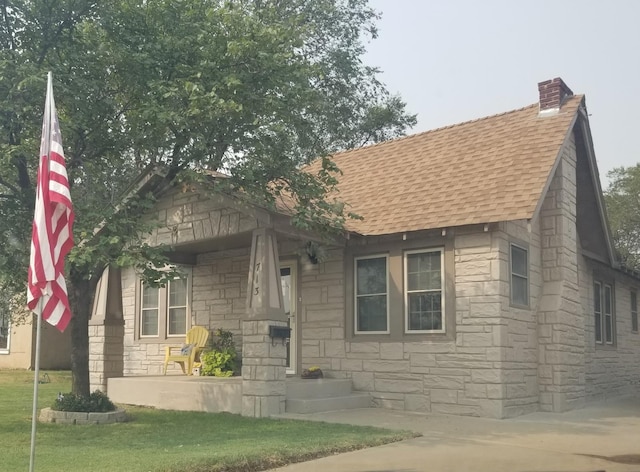 bungalow-style home featuring a front yard