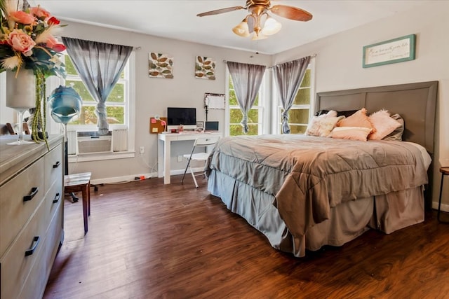 bedroom featuring dark hardwood / wood-style flooring, ceiling fan, and cooling unit