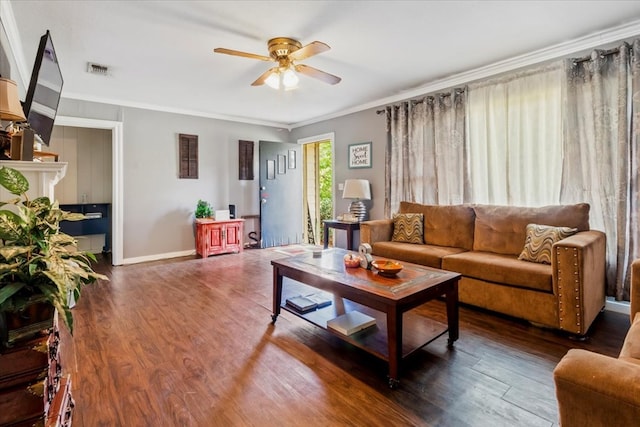 living room with ceiling fan, crown molding, and dark wood-type flooring