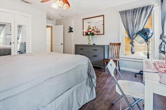 bedroom with ceiling fan and dark wood-type flooring