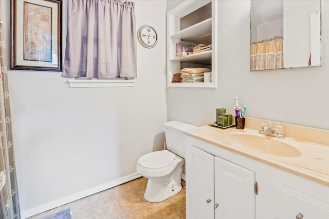 bathroom featuring tile patterned floors, vanity, and toilet