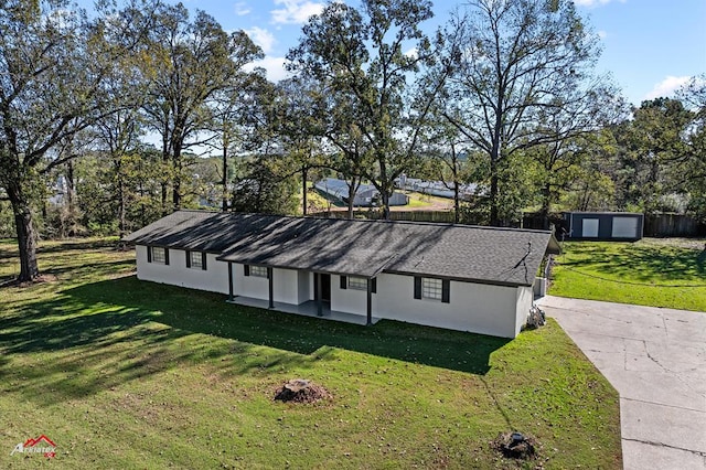 exterior space with an outbuilding, a garage, and a front lawn