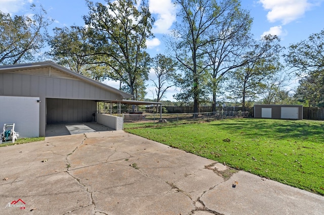 view of yard featuring an outbuilding and a carport