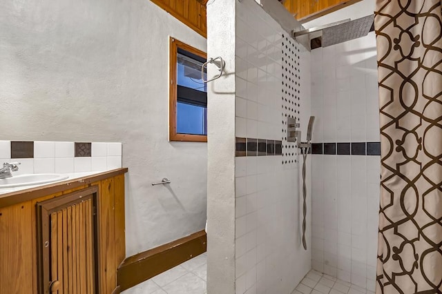 bathroom featuring tiled shower, tile patterned floors, and vanity