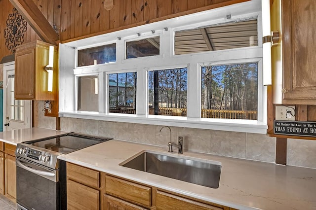 kitchen featuring a wealth of natural light, sink, and electric range