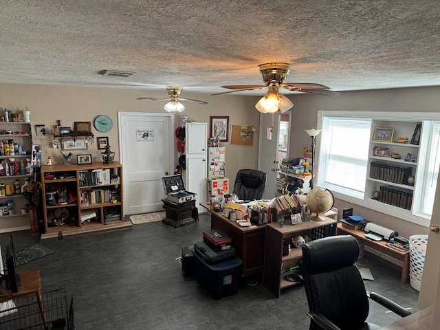 home office featuring visible vents, a textured ceiling, and ceiling fan