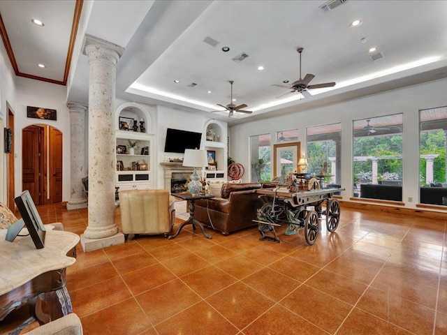 2102 Brentwood Dr, Lufkin, TX 75901 - living area featuring ornate columns, built in features, a raised ceiling, recessed lighting, and tile patterned flooring