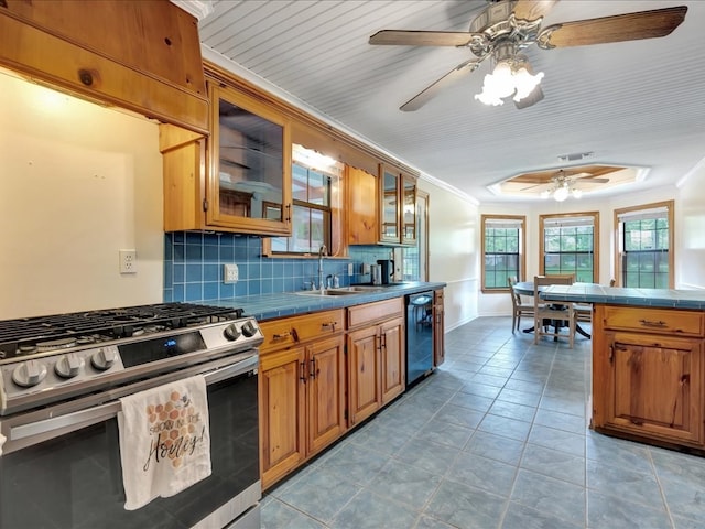 kitchen with dishwasher, ornamental molding, tile counters, and stainless steel gas range oven