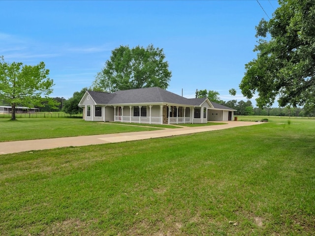 farmhouse inspired home featuring a garage, driveway, a front yard, and covered porch