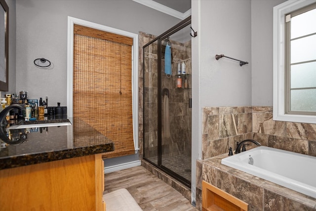 2607 Old Union Rd, Lufkin, TX 75904 - full bathroom featuring a sink, a garden tub, a stall shower, wood finished floors, and ornamental molding