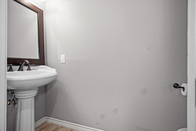 2607 Old Union Rd, Lufkin, TX 75904 - bathroom with baseboards, wood finished floors, and a sink