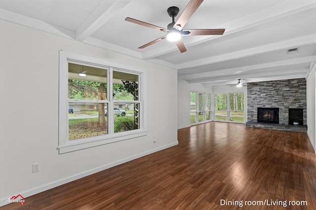 unfurnished living room with dark wood-style flooring, a fireplace, a ceiling fan, beamed ceiling, and visible vents