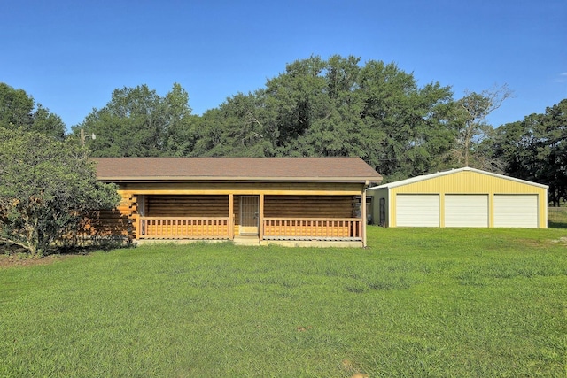 view of front of home with an outbuilding, a front yard, a porch, and a garage