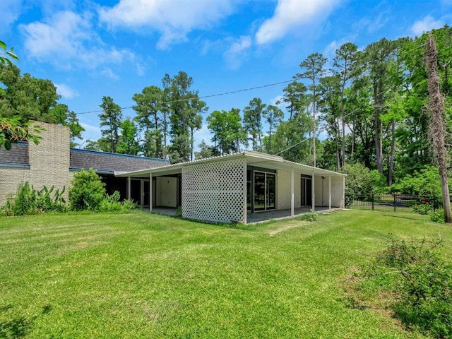 rear view of house with a lawn