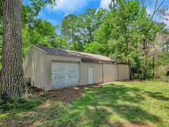 garage featuring a lawn