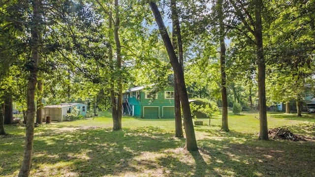 390 County Road 076, Jasper, TX 75951 - view of grassy yard featuring a garage